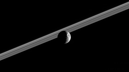 incredible image of Saturn's moon Mimas in front of the rings
