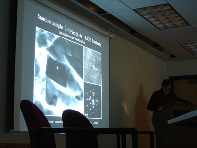 image of Dr. Brownlee and a sample of a comet particle