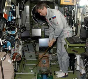 cosmonaut practicing hitting the golf ball on the space station. No, seriously.