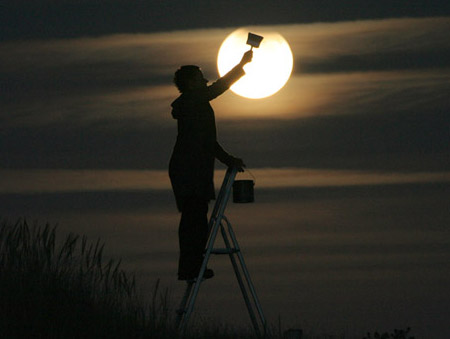 image of someone painting as if they are making the lunar eclipse