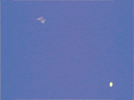 Image of the space station passing near Venus in the sky