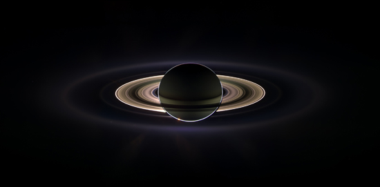 Saturn from Cassini, back lit by the Sun with a glow in the background