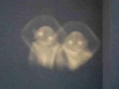 image of two alien-like apparitions that appeared on a wall in Canada