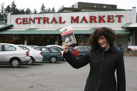 Picture of Carol holding up my book at the fabled Central Market of Seattle