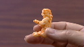 Picture of a Cheeto that looks vaguely like a guy with his arm sticking out