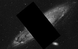 Image of the Andromeda galaxy with the middle blocked so you can see the warp