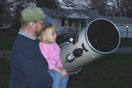 image of Dr. Plait showing his daughter the Moon
